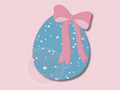 Blue Easter egg with pink bow on a pink background