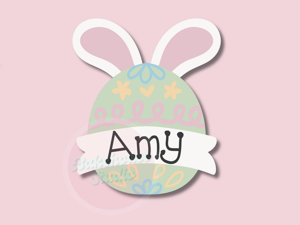 Easter egg-shaped name tag with bunny ears on a pink background